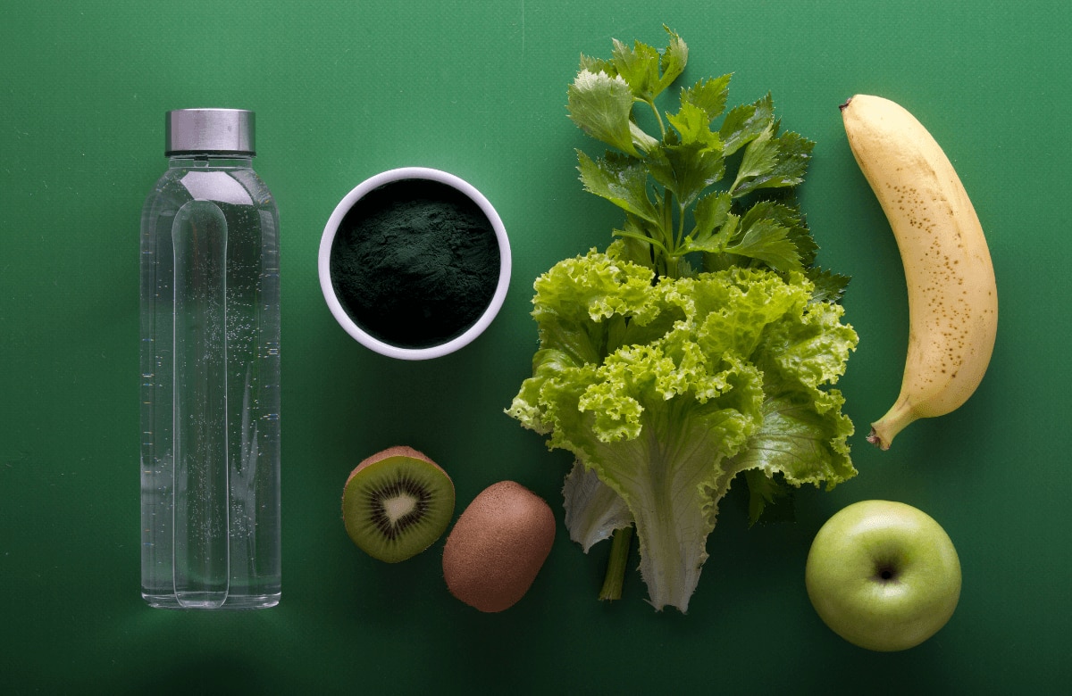 bottle of water and healthy fruit and green veg