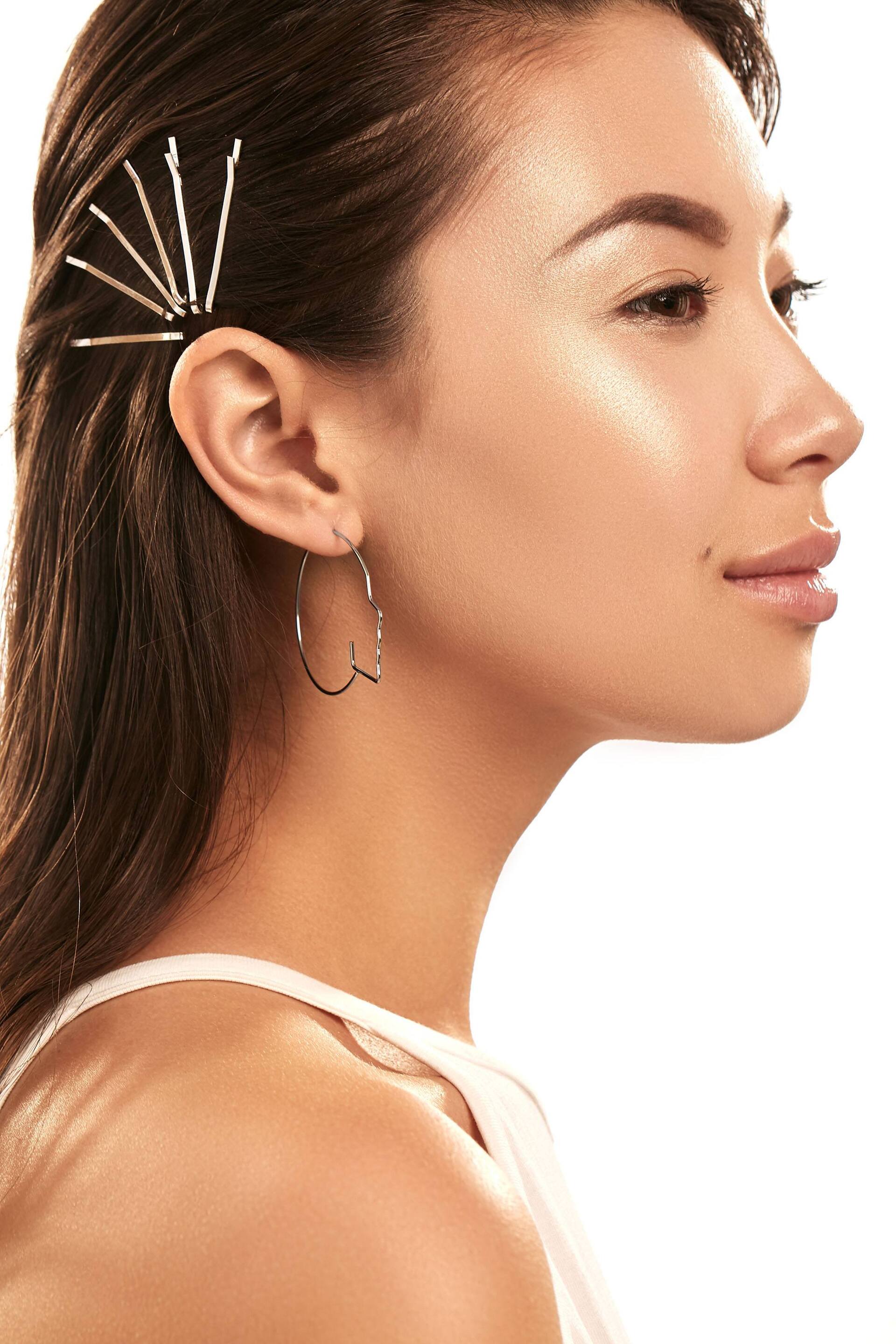 woman withb long brown hair and bobby pins hairstyle