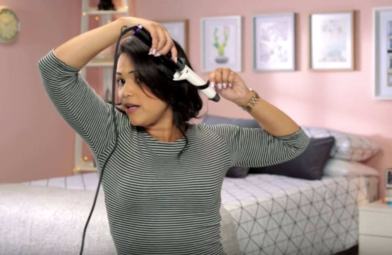 woman creating a faux bob hairstyle