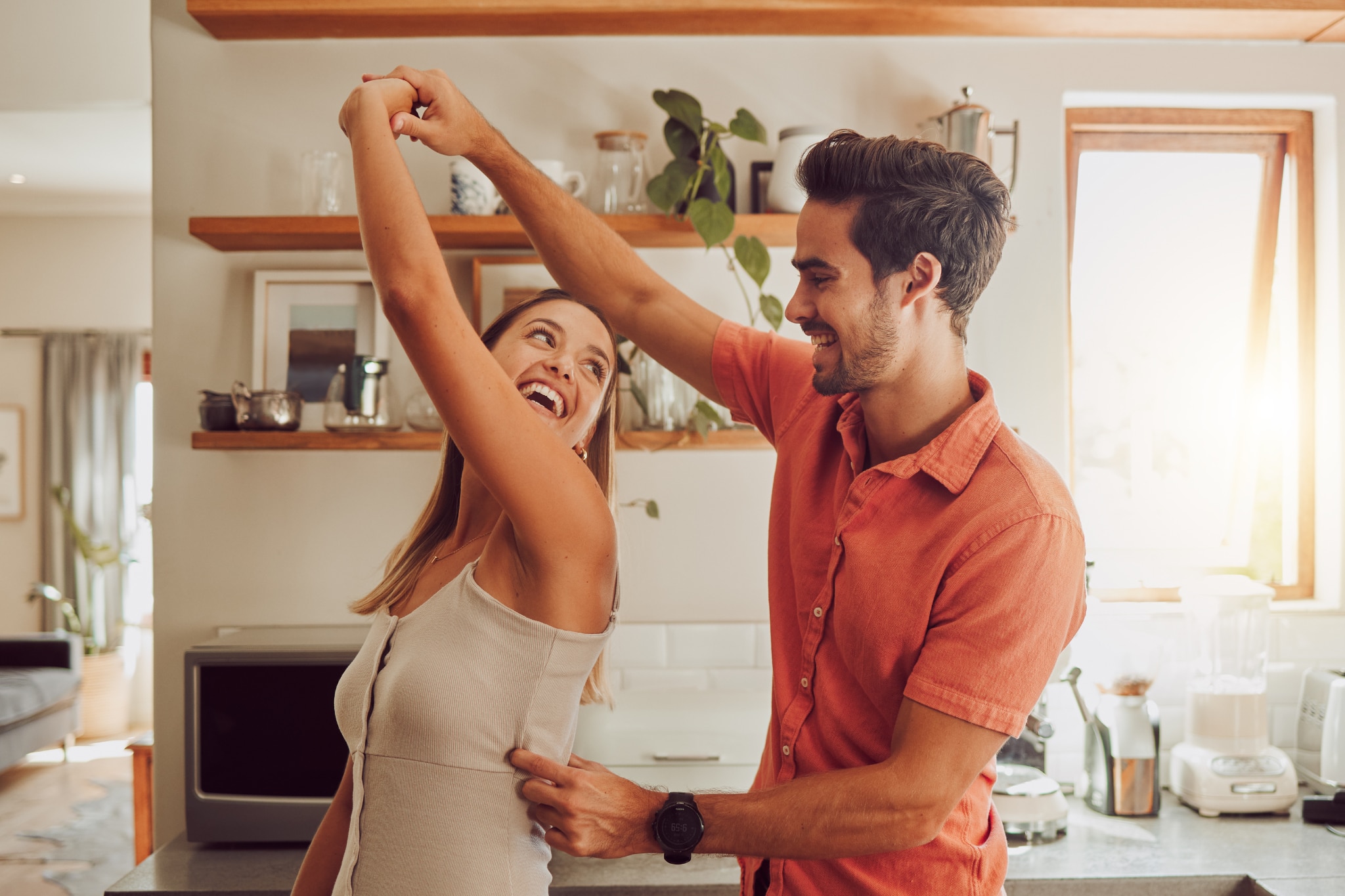 Couple dancing in their kitchen one wearing deodorant one wearing antiperspirant