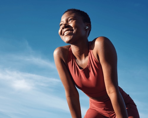Fit African American woman stretching after a sweat producing workout