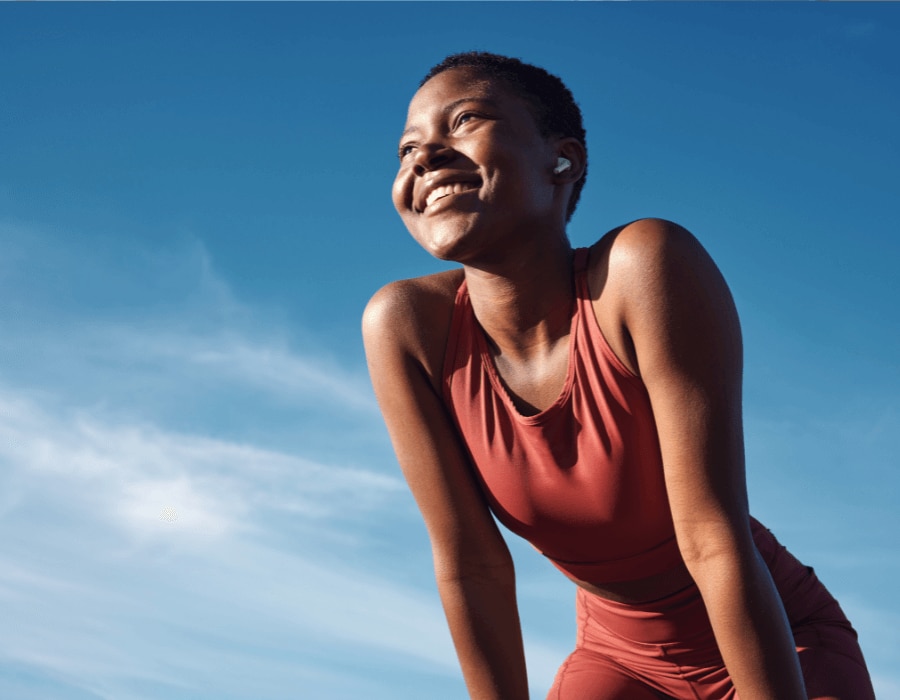 Fit African American woman stretching after a sweat producing workout