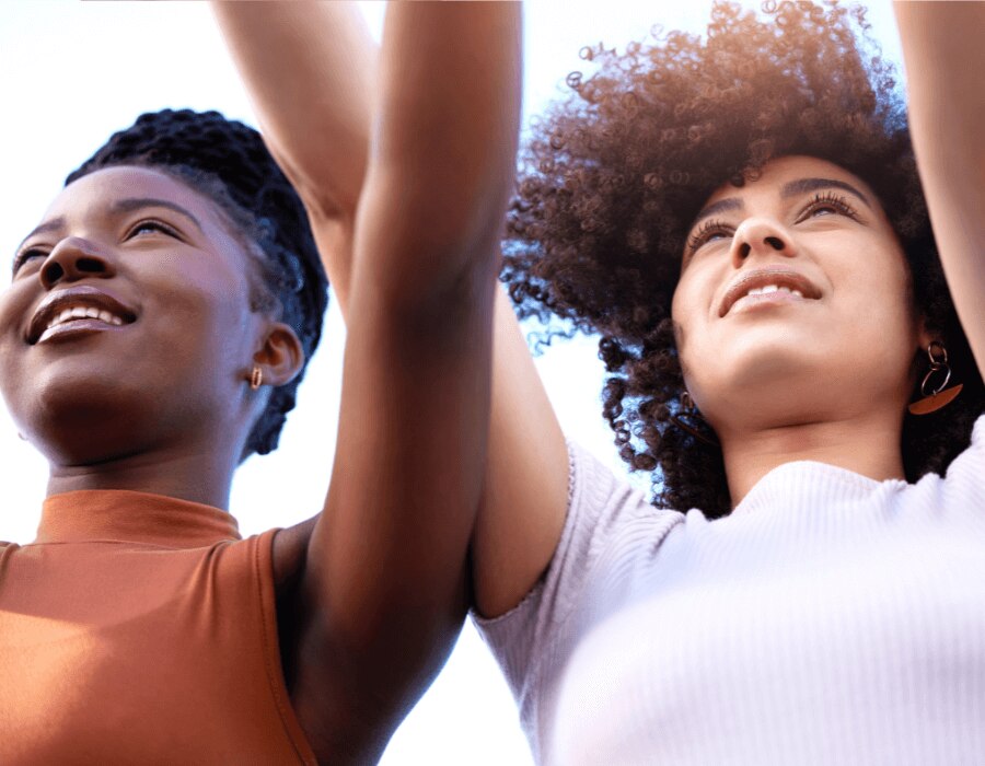 Two women outdoors showing their armpits