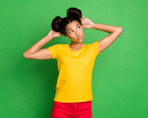 Young African American woman with her arms in the air considering an armpit detox
