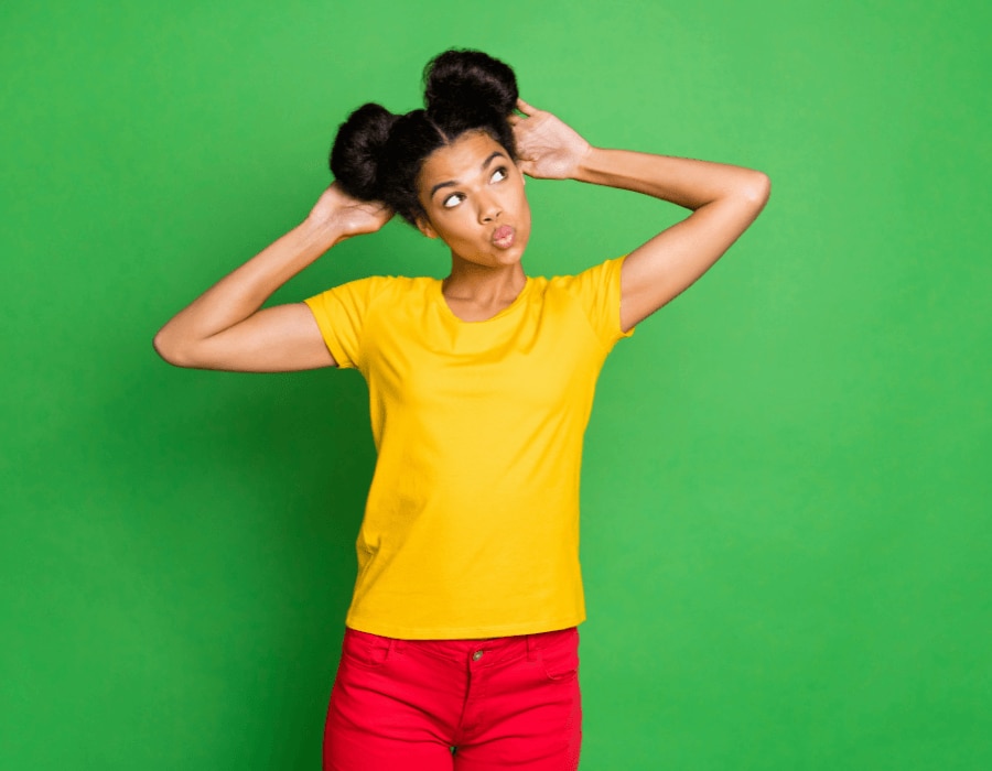 Young African American woman with her arms in the air considering an armpit detox