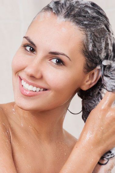 Mulher lavando o cabelo no chuveiro