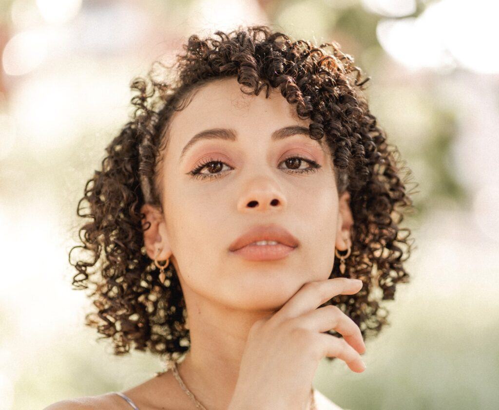 Mulher com cabelo cacheado depois de fazer desprogressiva