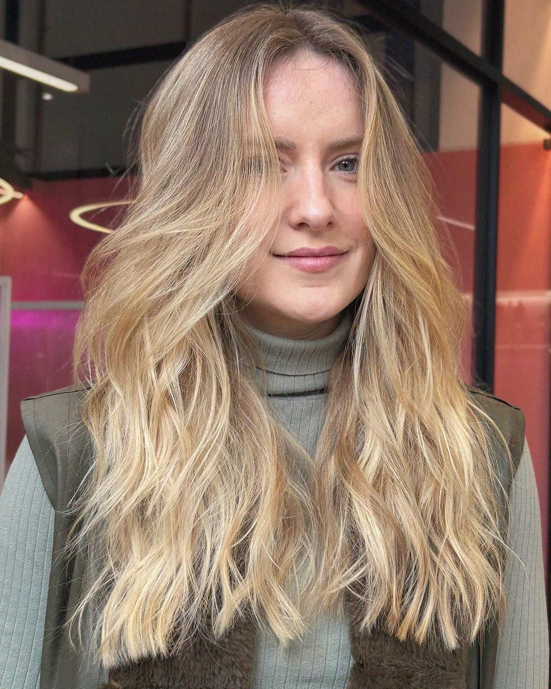 mulher com cabelo loiro desfiado em camadas