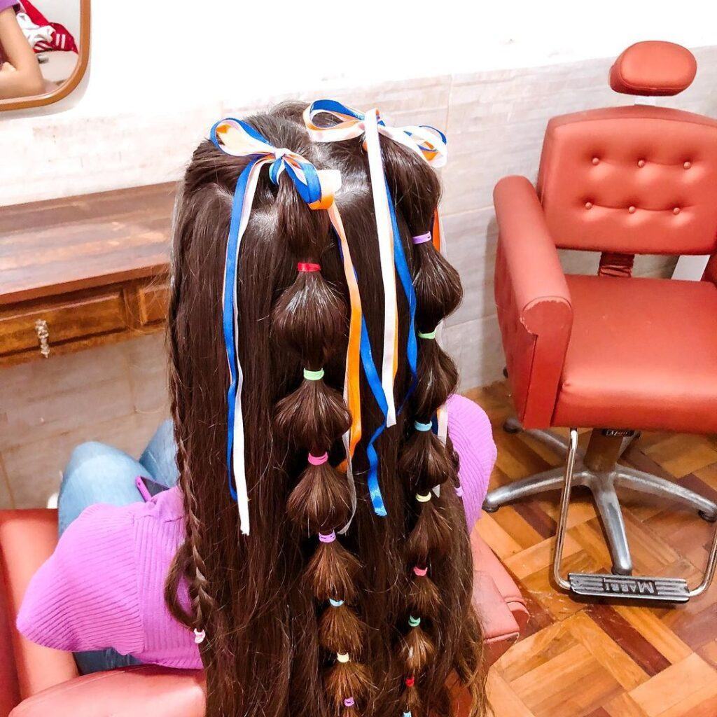 penteado de festa junina de trança bolha com liguinha e fitas