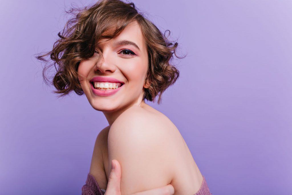 mulher com cabelo ondulado curto com franja
