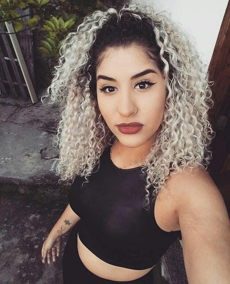 Mulher com cabelo platinado cacheado semipreso
