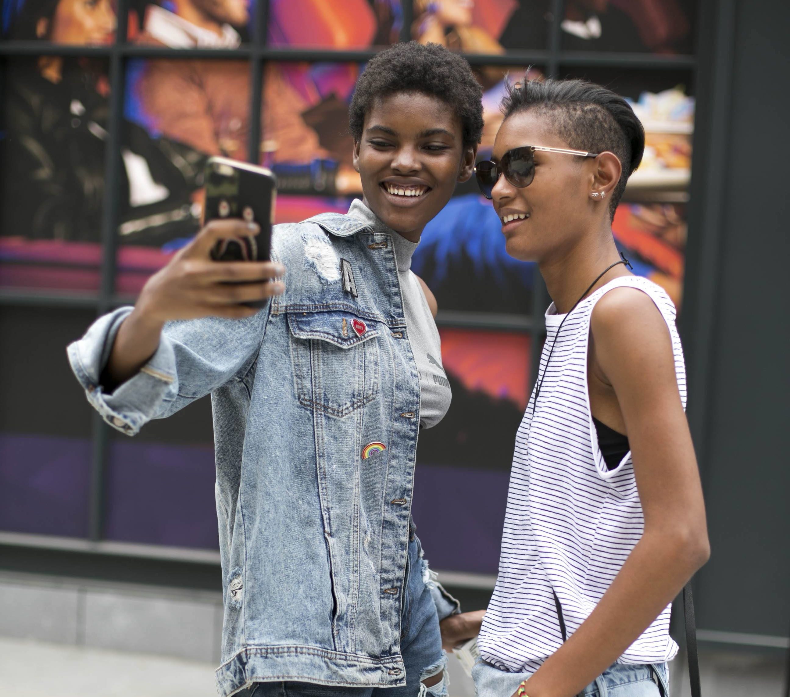 Duas mulheres conversa e usam inspiração hip hop no visual