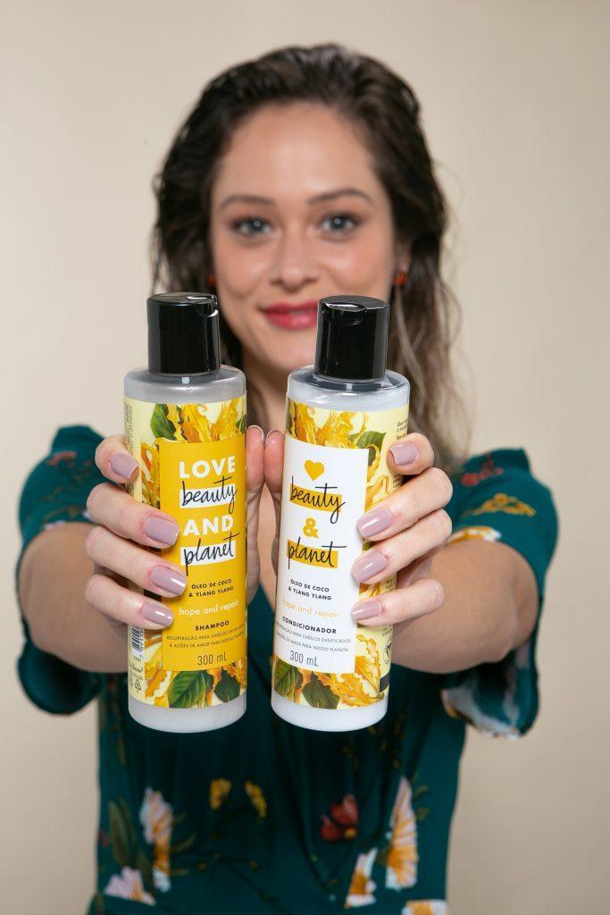 Mulher segura shampoo e condicionador