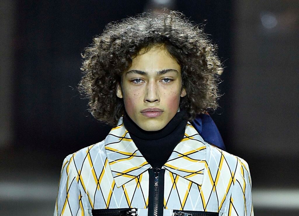 Modelo com textura natural nos cabelos das semanas de moda masculina