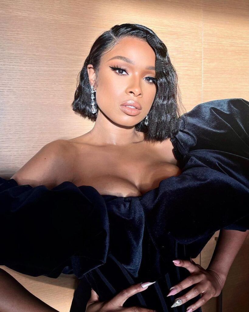 Atriz e cantora Jennifer Hudson posa com cabelo chanel curto preto no rosto triangular e vestido de festa preto