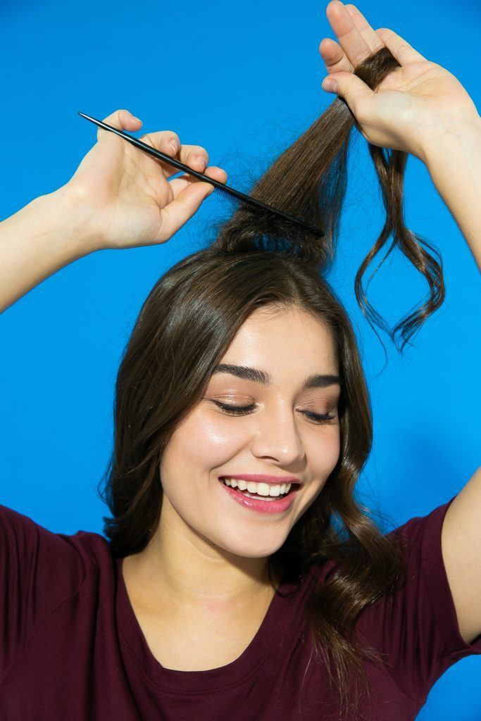 Mecha em cabelo liso sendo penteada para fazer volume 