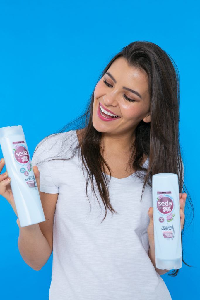 Modelo mostra shampoo e condicionador para fazer trança de princesa