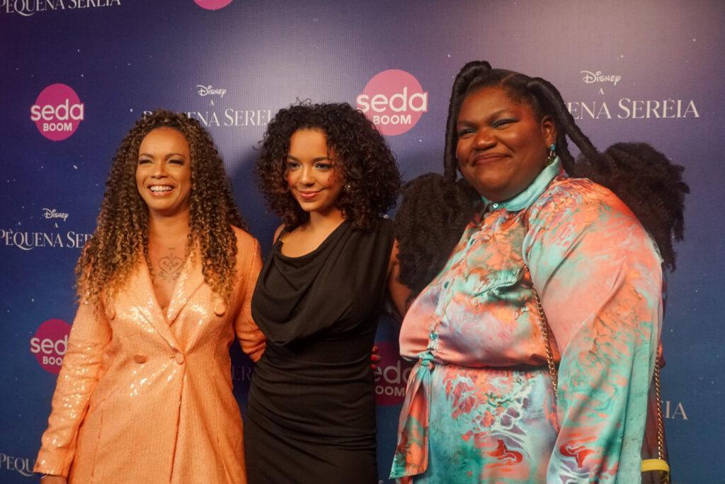 três mulheres negras sorrindo para foto
