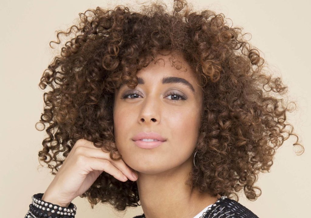 mulher com o cabelo cacheado curto solto