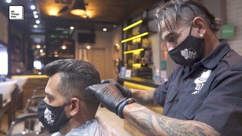 homem cortando o cabelo com profissional