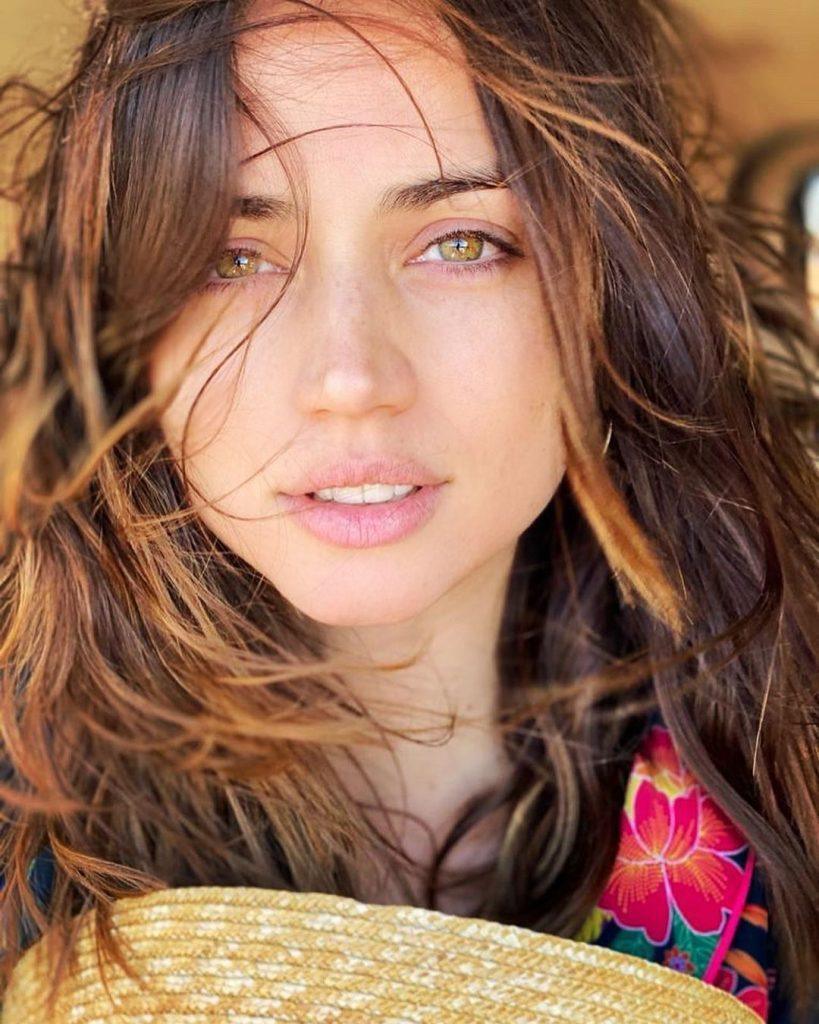 Foto da atriz Ana de Armas com cabelos longos e esvoaçantes