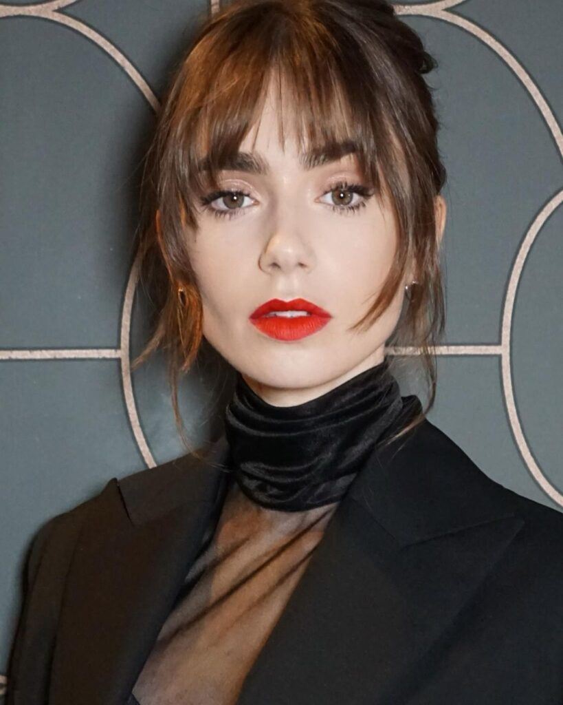 Atriz Lily Collins com a franja da moda chamada bottleneck bangs