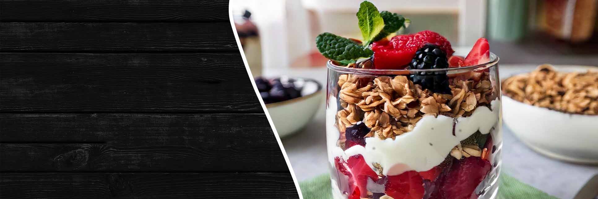 Close-up of glass with ice cream and berry parfait.
