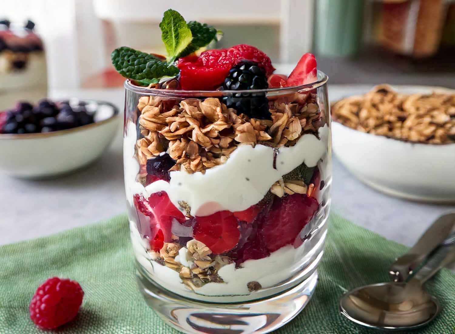 Close-up of glass with ice cream and berry parfait.