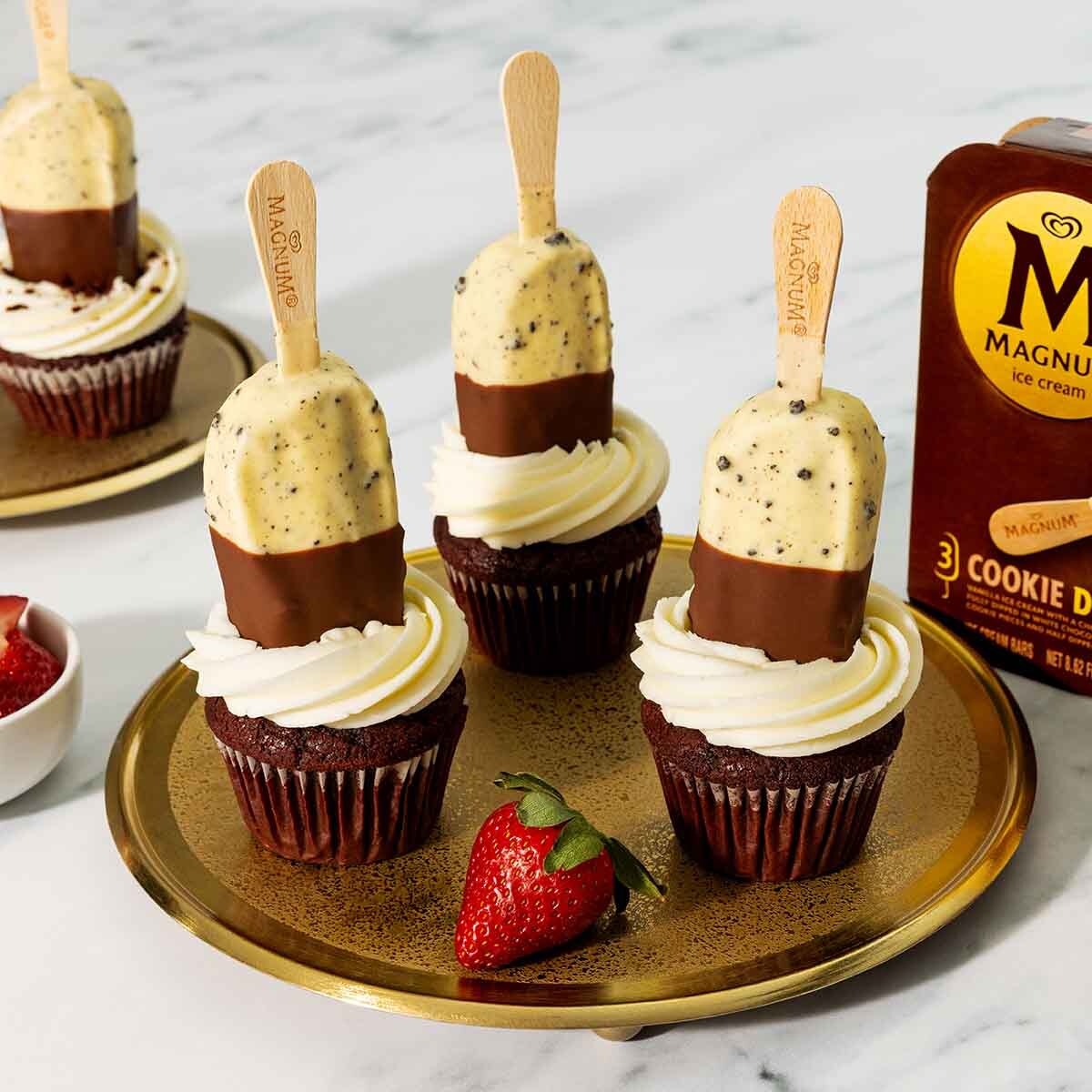 Red velvet cupcakes topped with Magnum Cookie Duet bars.