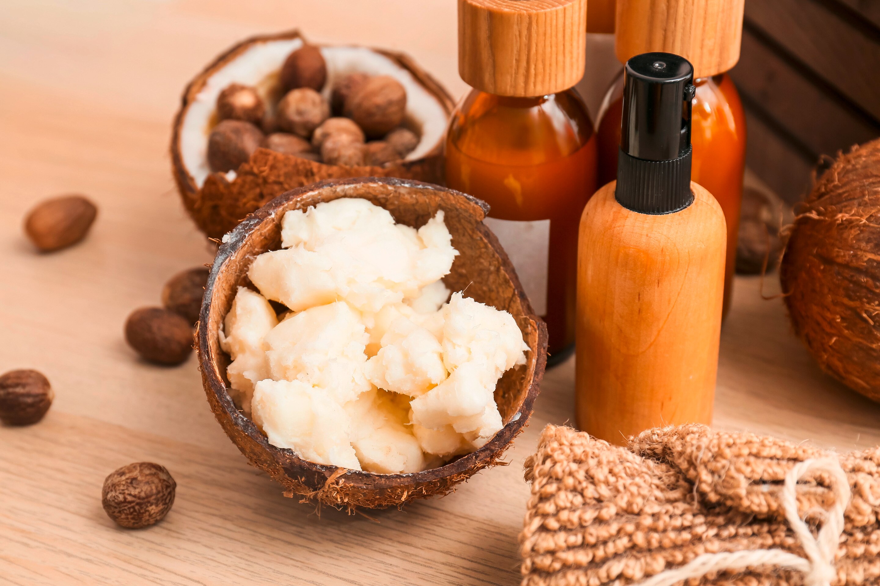 Shea butter and coconut oil closeup on table.