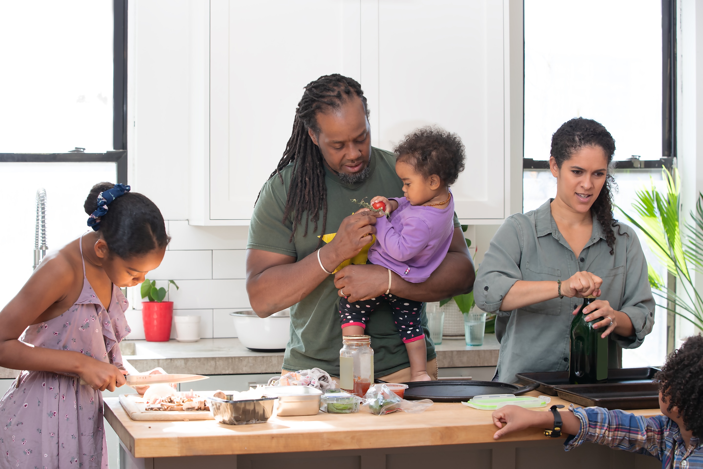 Family gathering together in the kitchen before school. 