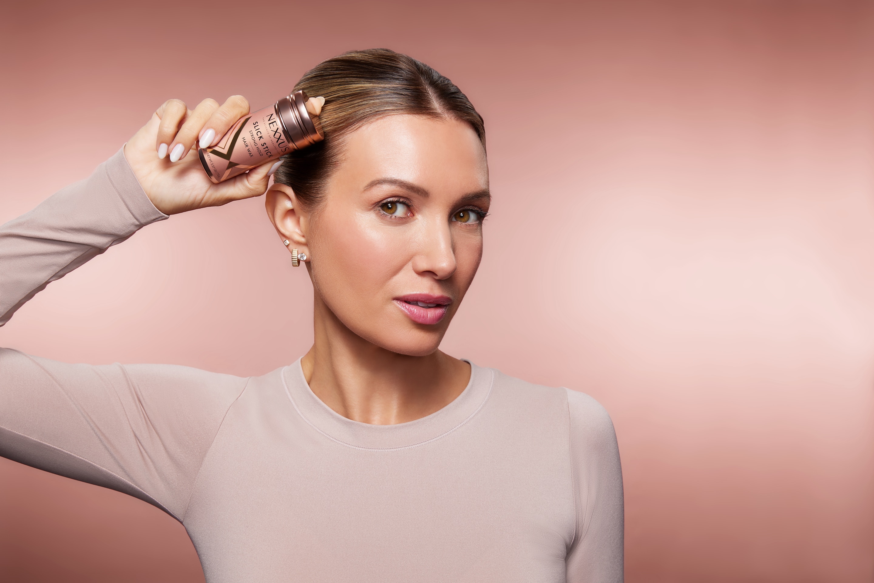 woman holding Nexxus Slick Stick