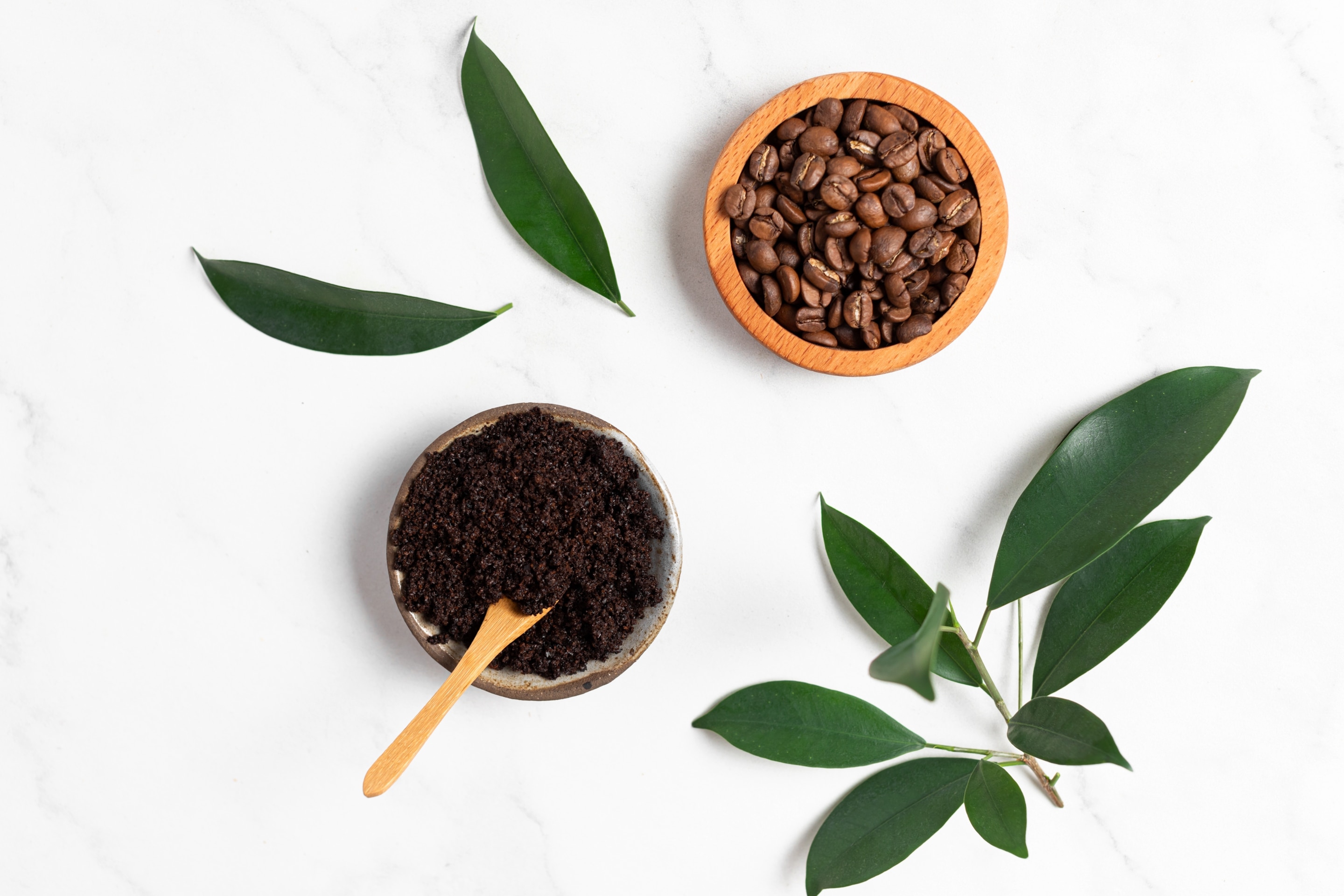 bã cà phê bã cà phê là gì bát đựng bã cà phê màu nâu xếp cạnh bát đựng hạt cà phê trên nền trắng