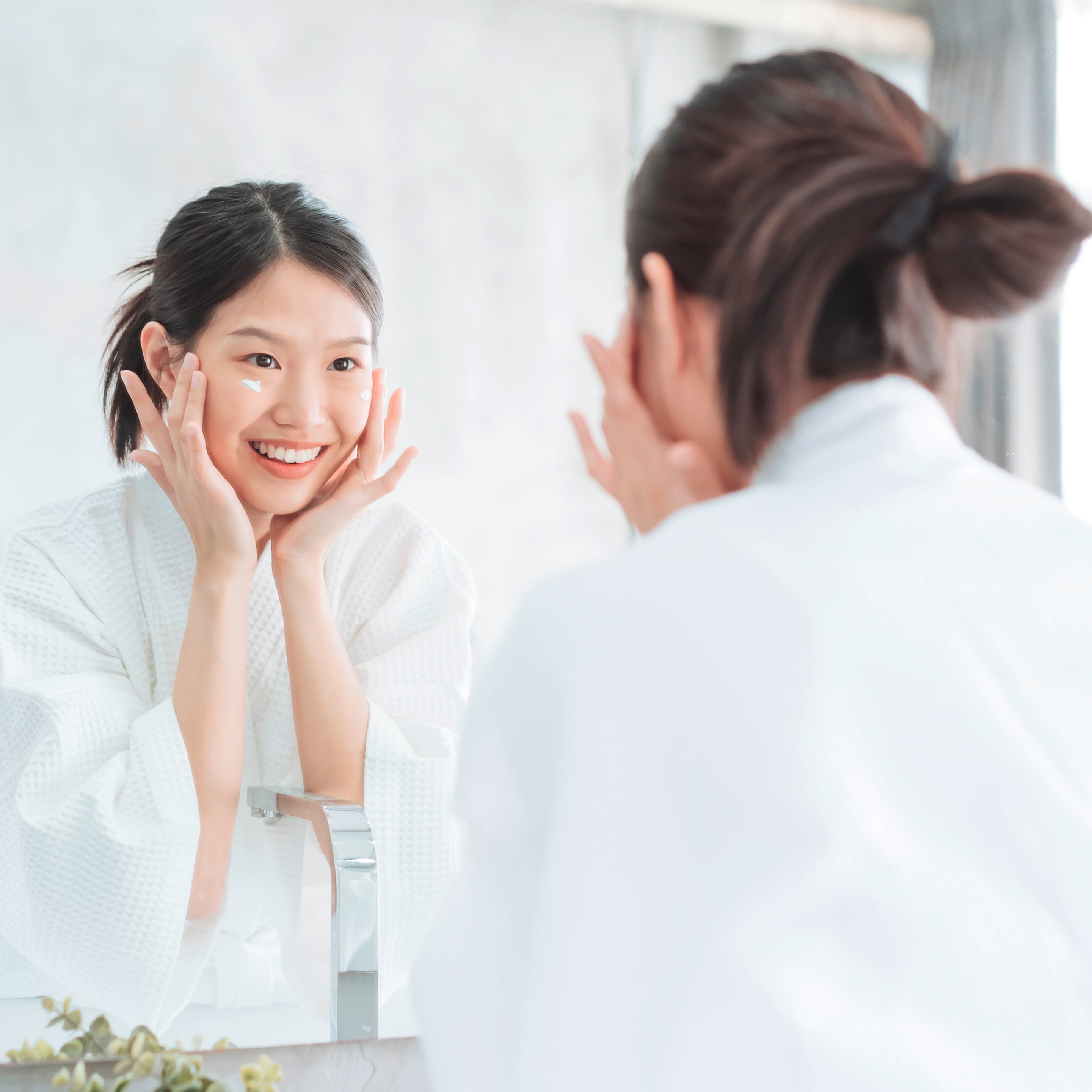 Woman applying face cream on her skin.