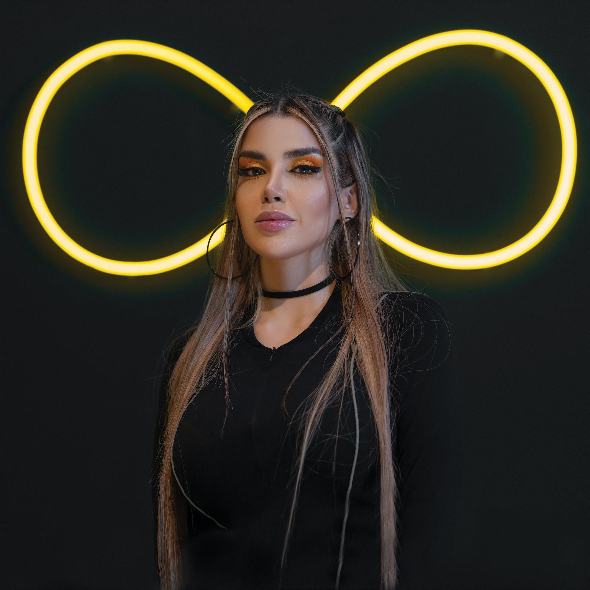 TikTok hairstyles: woman with long wavy hair that's ties half-up with two loose pieces on the sides of her face