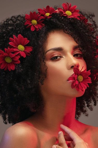 Woman with afro an flowers Valentine's hairstyles