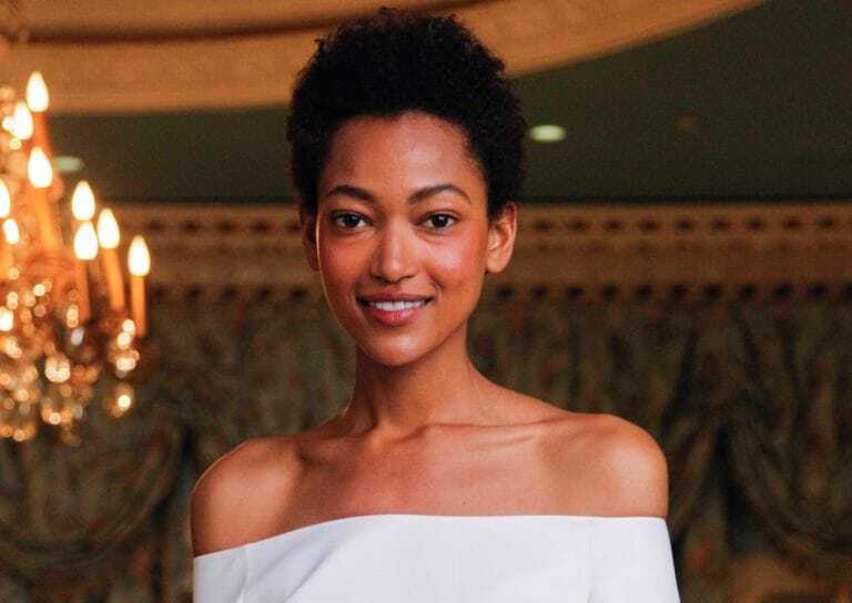 Deep conditioner for natural hair: Woman with short natural afro hair wearing a off the shoulder light blue dress.
