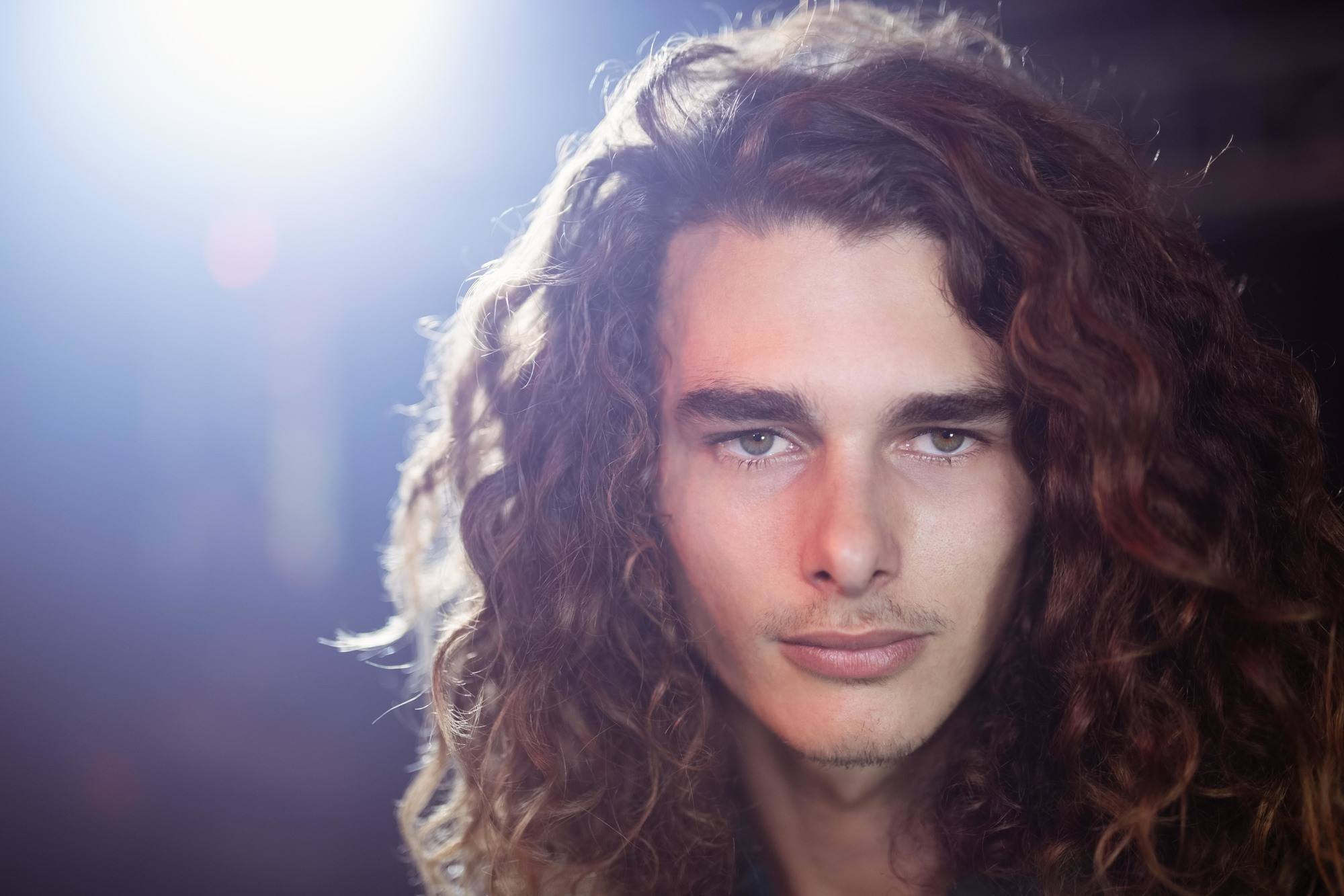 man with long curly hair