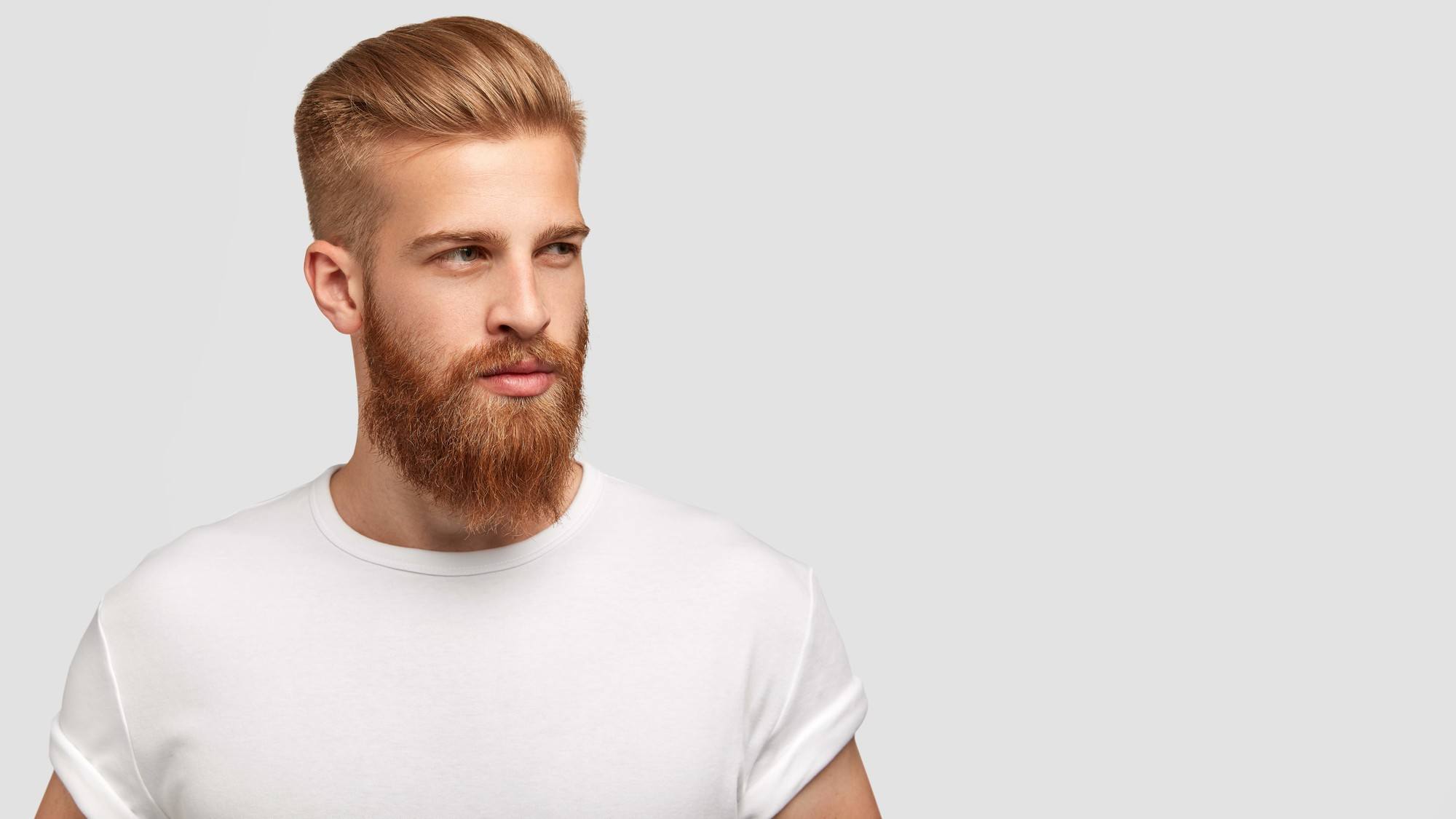 summer looks for men: Man with a beard and a comb over hairstyle