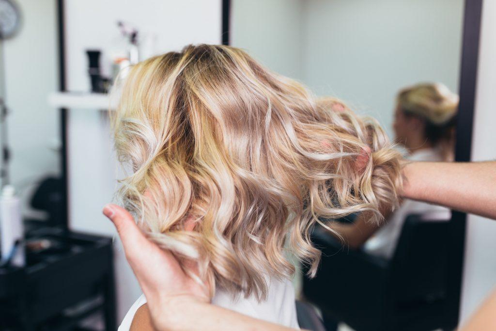 Woman with textured hair, going from brunette to blonde