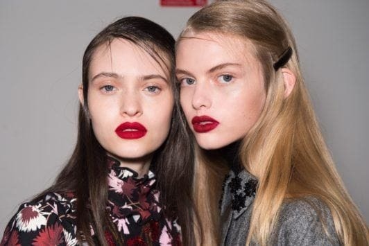 Straight hairstyles: Models at Rochas FW18 show with side parted long straight hair pinned back with a barrette hair accessory.
