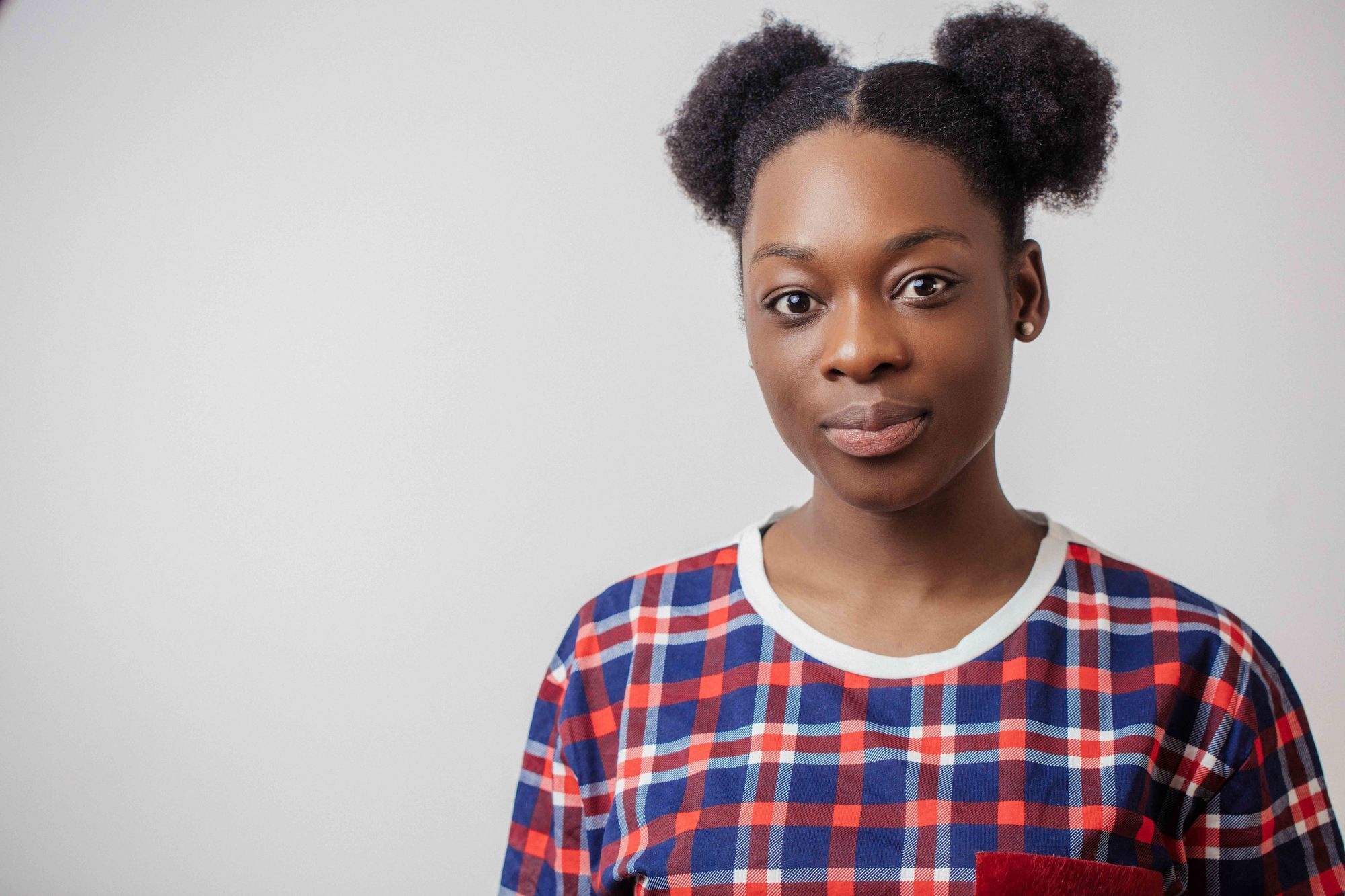 Woman with natural hair wearing two space buns, gym hairstyle