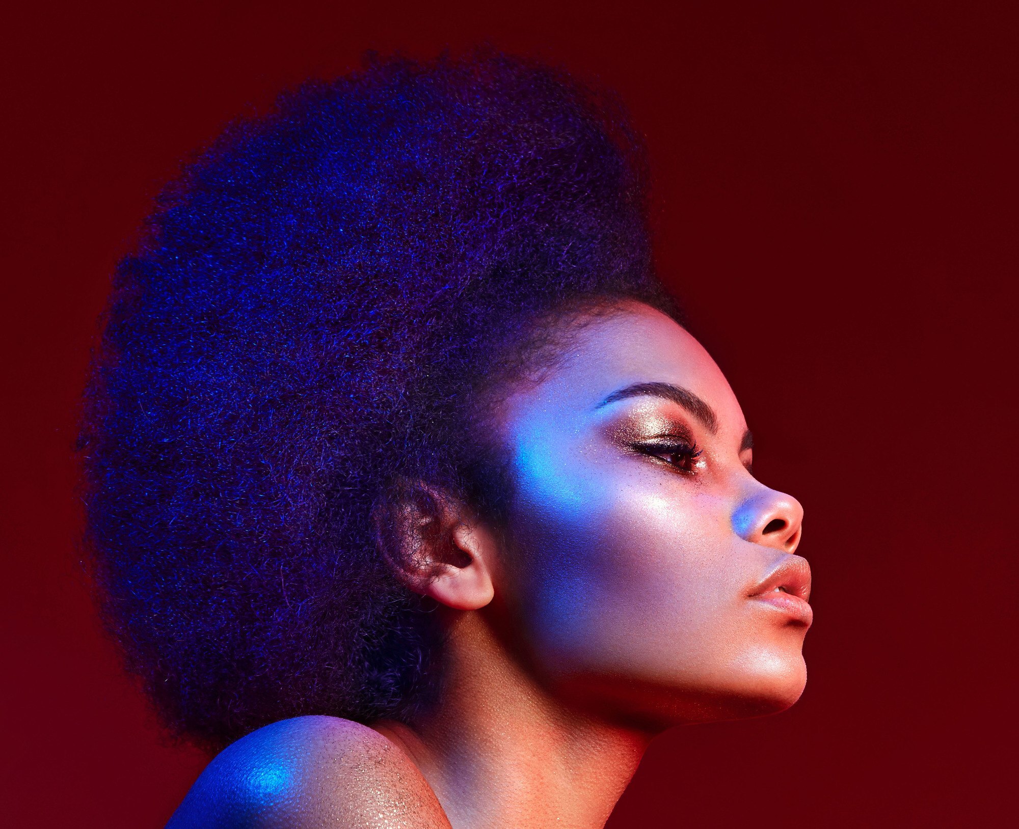 best hair products: woman with a big healthy-looking afro