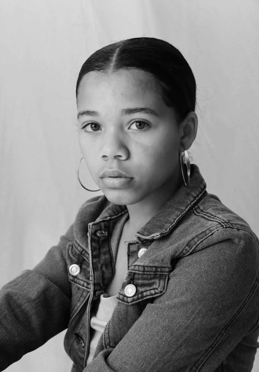 2022 hair trends: woman with her hair tied back in a sleek style with a middle path