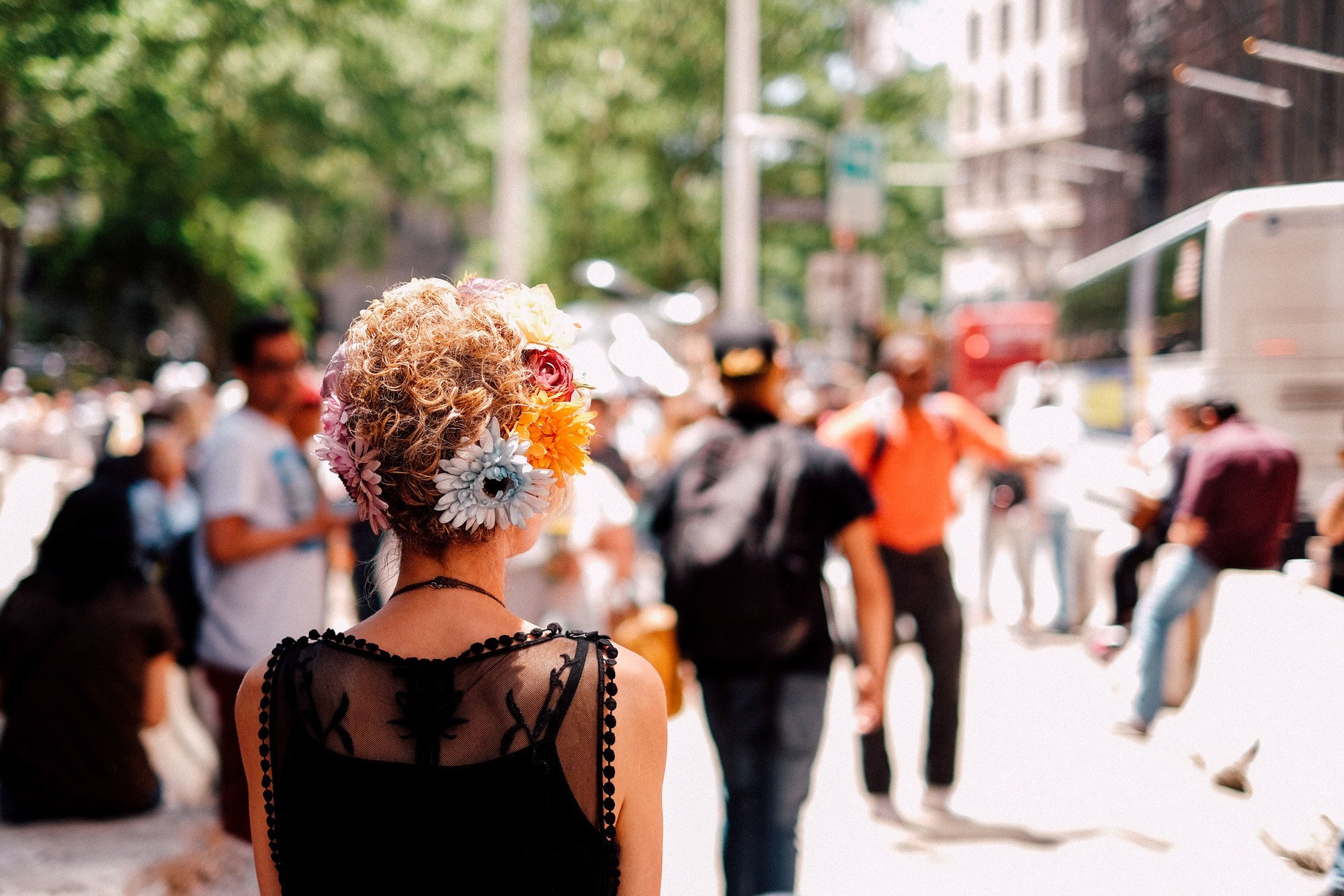 woman with flowers in her short blonde hair