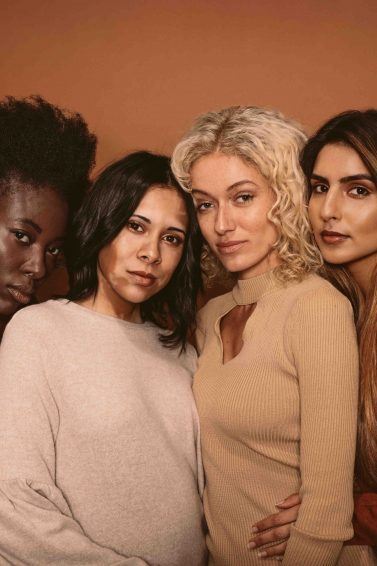 four woman standing together