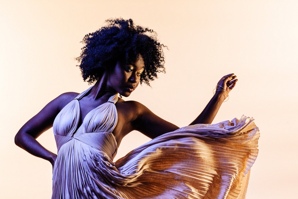 dark skinned woman with natural hair curls