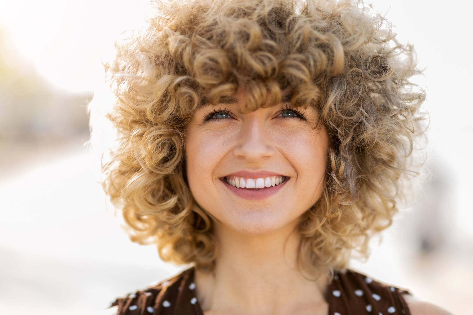 woman with large blonde curls