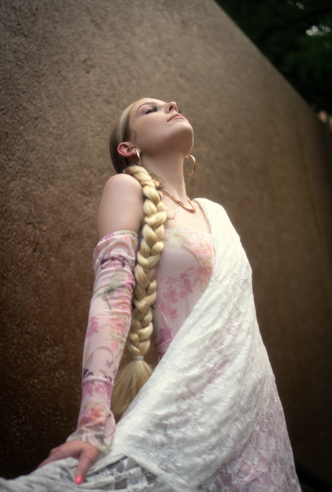 disney hairstyles: woman with very long blonde hair styled in a single braid