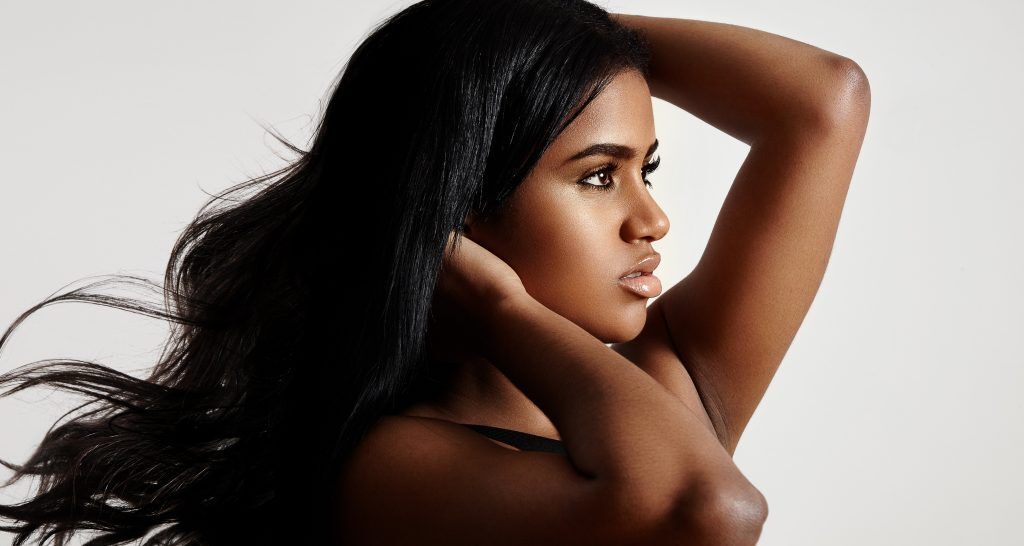 gemini hairstyles: woman with long sleek wavy dark hair